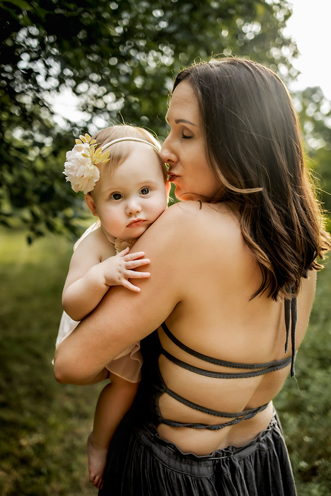 Mom and baby together at a first birthday photo session that also includes a cake smash session.