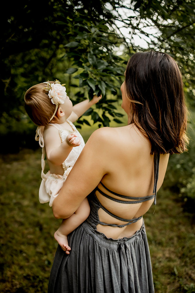 Mom and baby together at a first birthday photo session that also includes a cake smash session.