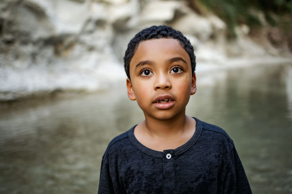 Young boy from Little Elm, TX looks up while at a session in Frisco Texas with photographer, Anna Roorda