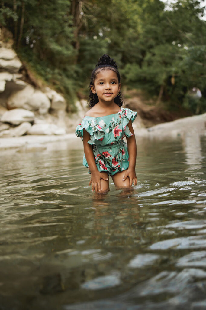 2 year old girl from Little Elm, TX plays in the water at the rock quarry while at a session in Frisco Texas with photographer, Anna Roorda
