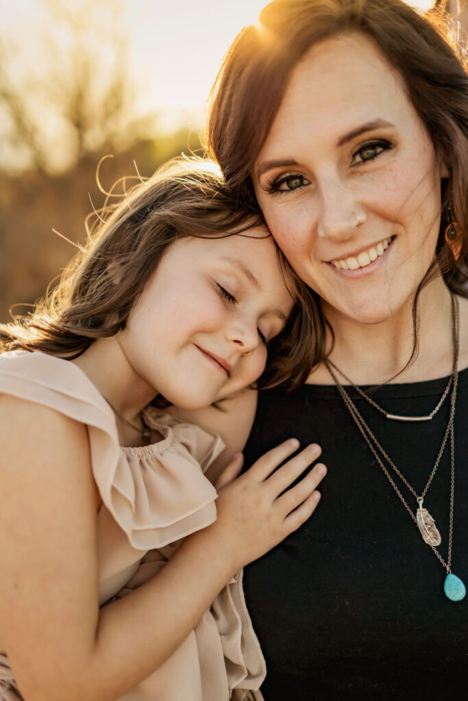 Mother and daughter laugh in the sunshine at a photo session at Lake Grapevine with Anna Roorda Photography.