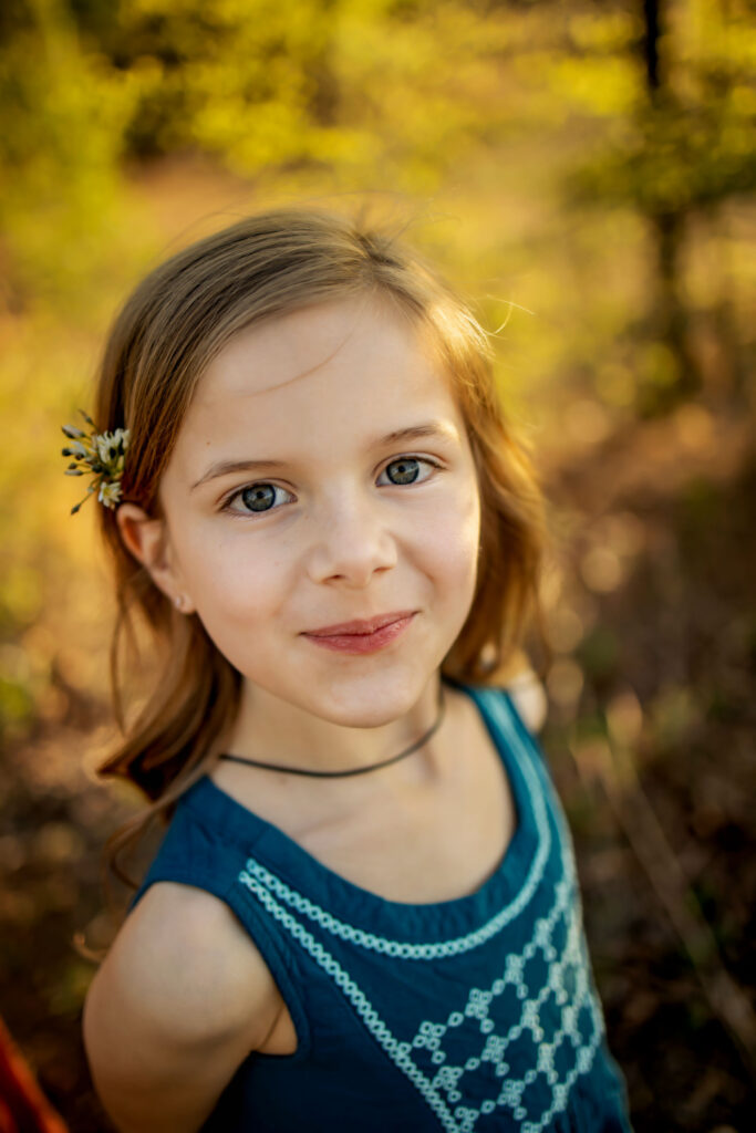 A young girl plays in the sunshine at a spring photo session at Lake Grapevine with Anna Roorda Photography.
