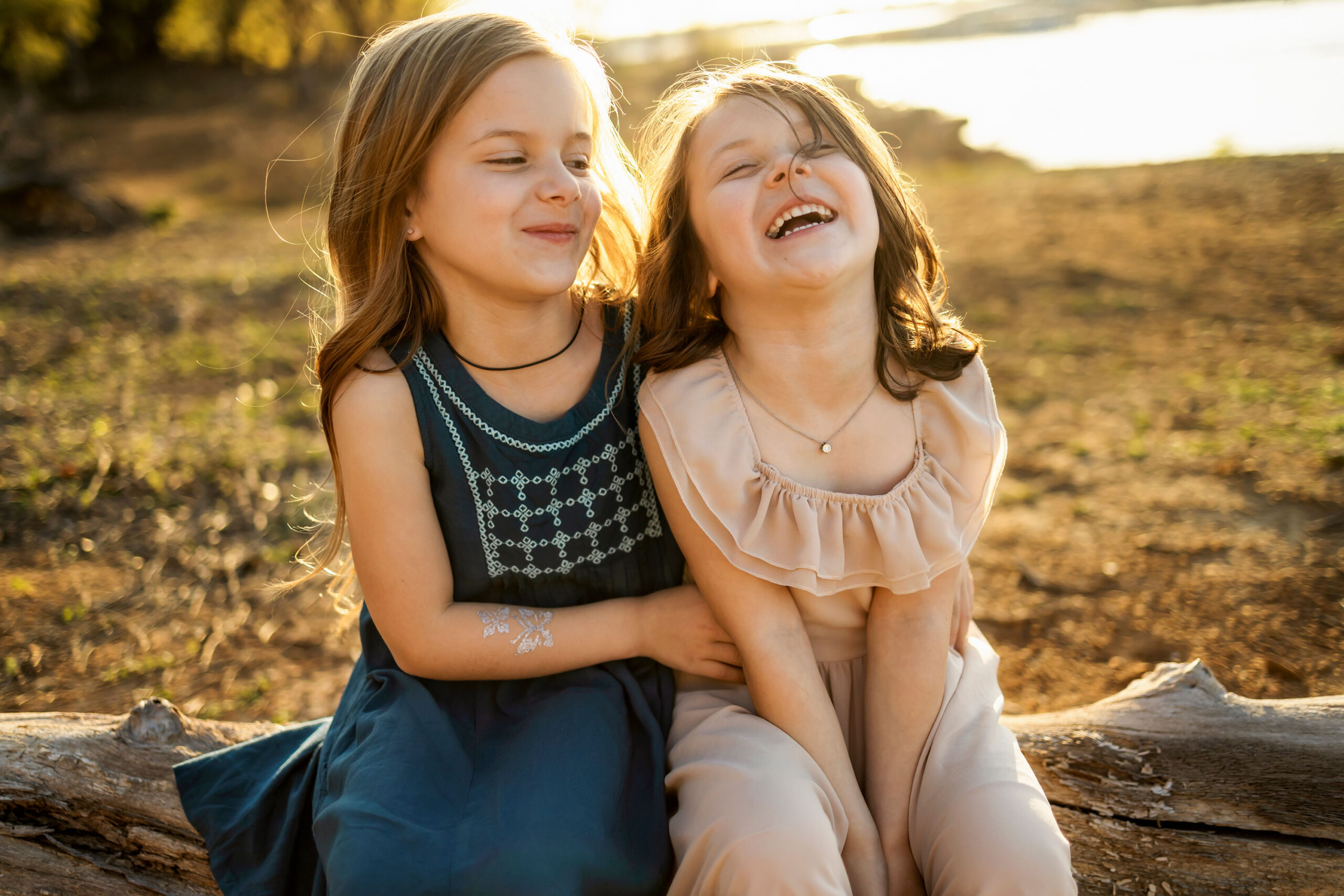 Sisters laughing at a family photo session in Grapevine, TX with Anna Roorda Photography