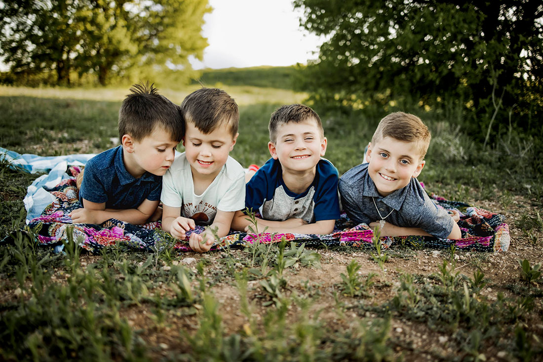 Four boys play while at a session with Anna Roorda Photography in Plano, TX at arbor hills nature preserve.