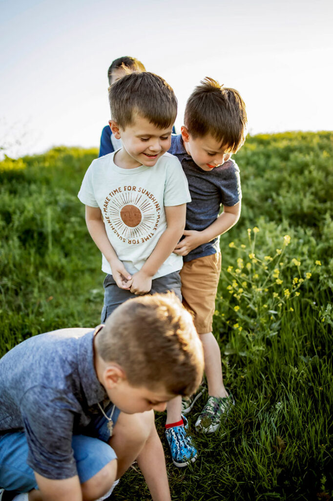 Four young sibling boys play while at a session with Anna Roorda Photography in Plano, TX at arbor hills nature preserve.