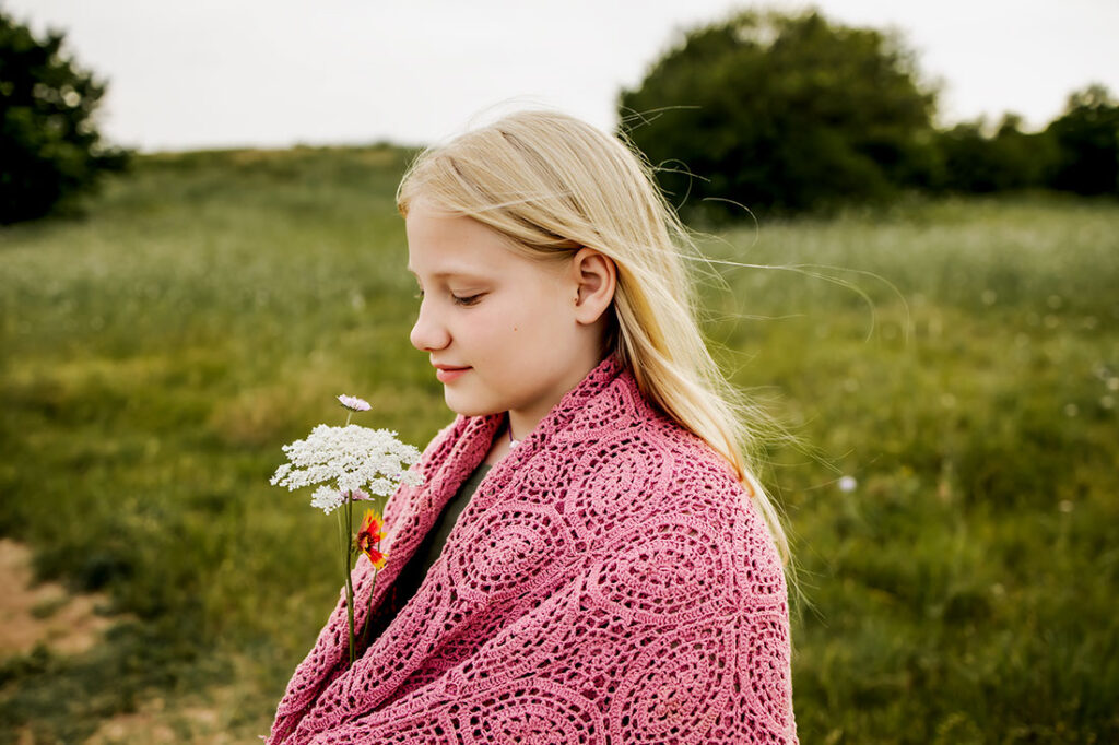 Young girl from Carrollton, TX hold a bundle of wild flowers in Plano, TX at Arbor Hills Nature Preserve.