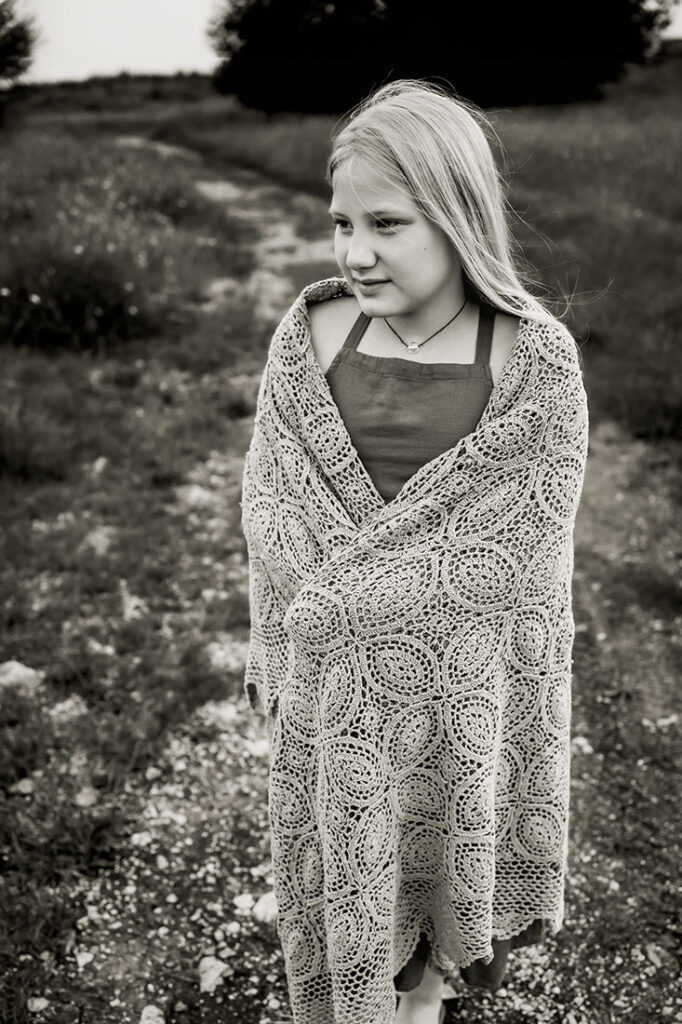 Black and white image of a young girl walking in the wildflowers in Arbor Hills in Plano, TX.