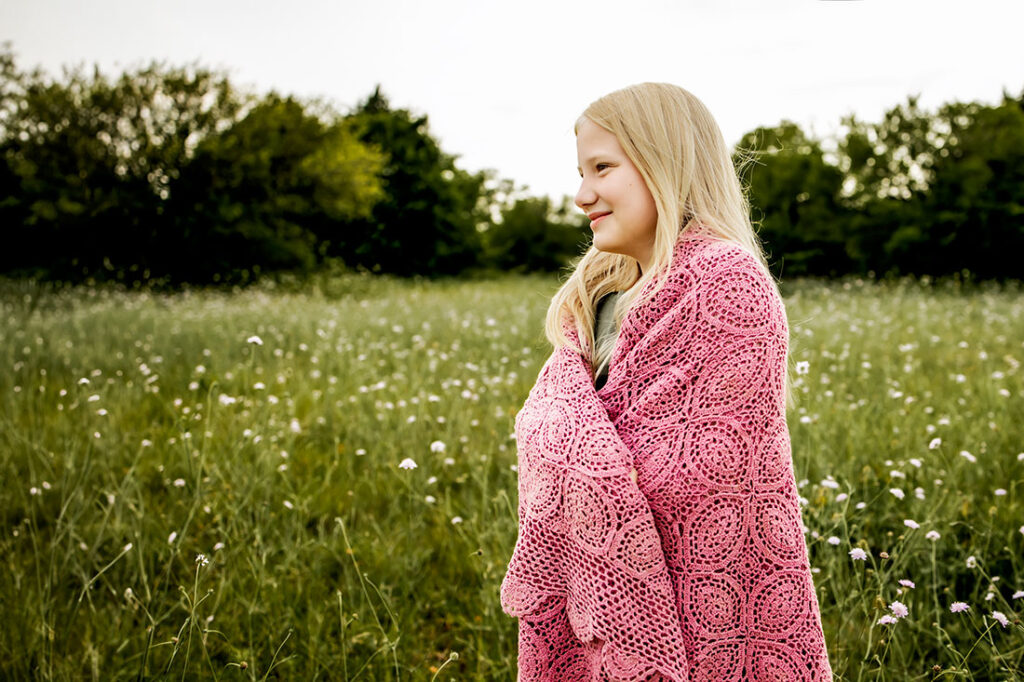 Young girl from Carrollton, TX walks in a field of wild flowers in Plano, TX at Arbor Hills Nature Preserve.