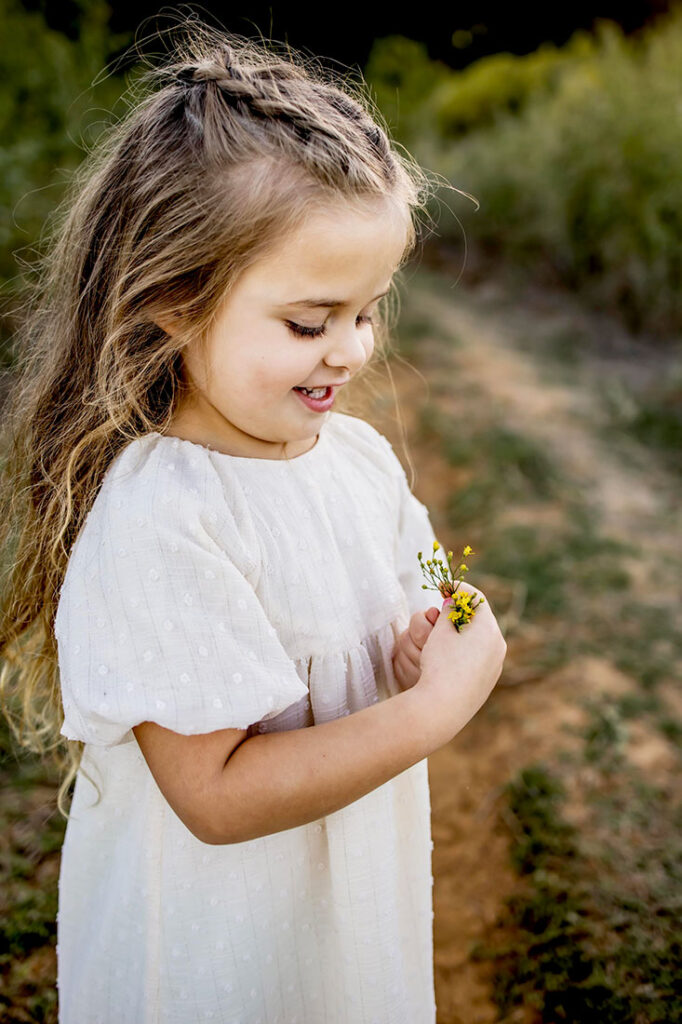 A little girl admires her wild flowers in  Southlake Texas.