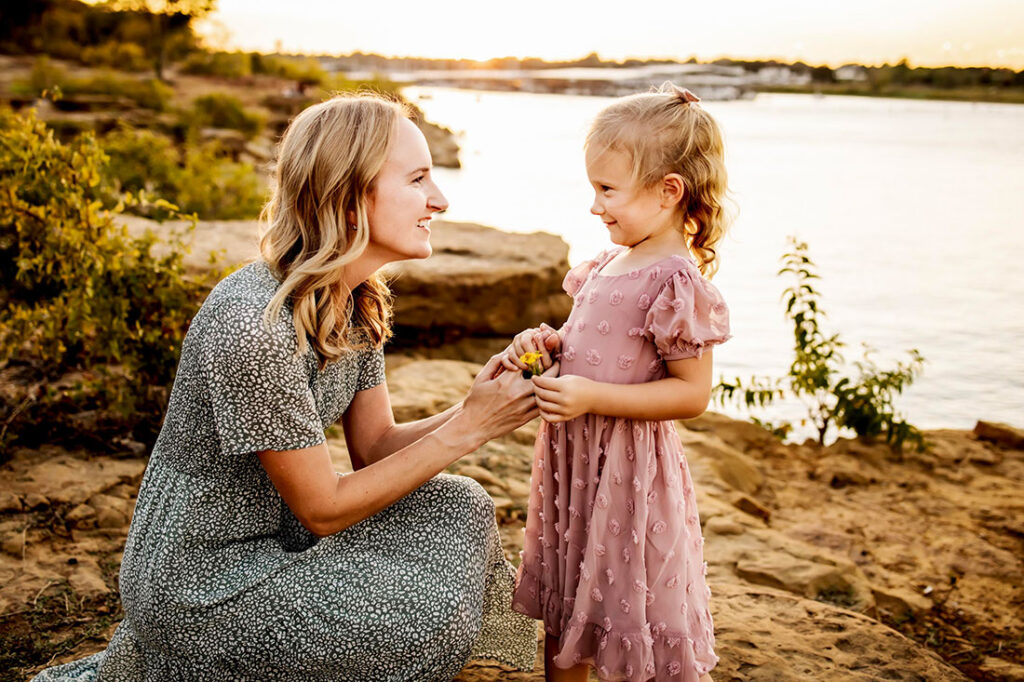 A mom and daughter smile at each other at a session in Grapevine Texas.
