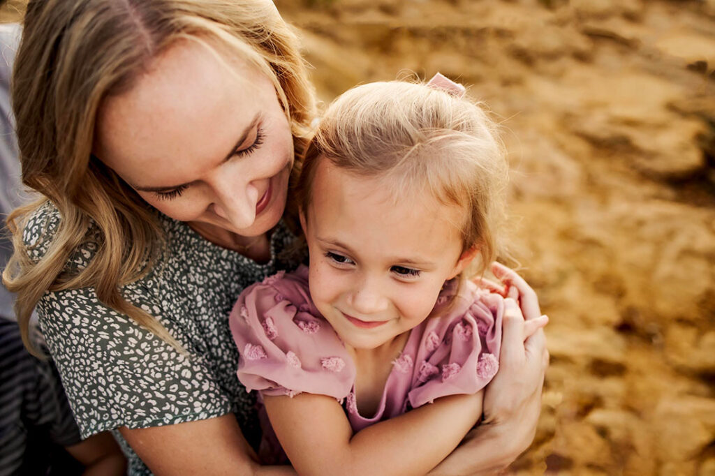 A mom and daughter embrace each other while at a photo session with Anna Roorda Photography.