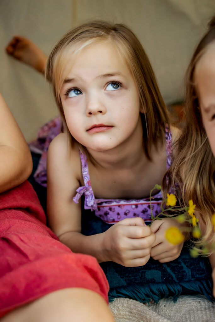 Two sisters in a tent in Flower mound, TX with wild flowers