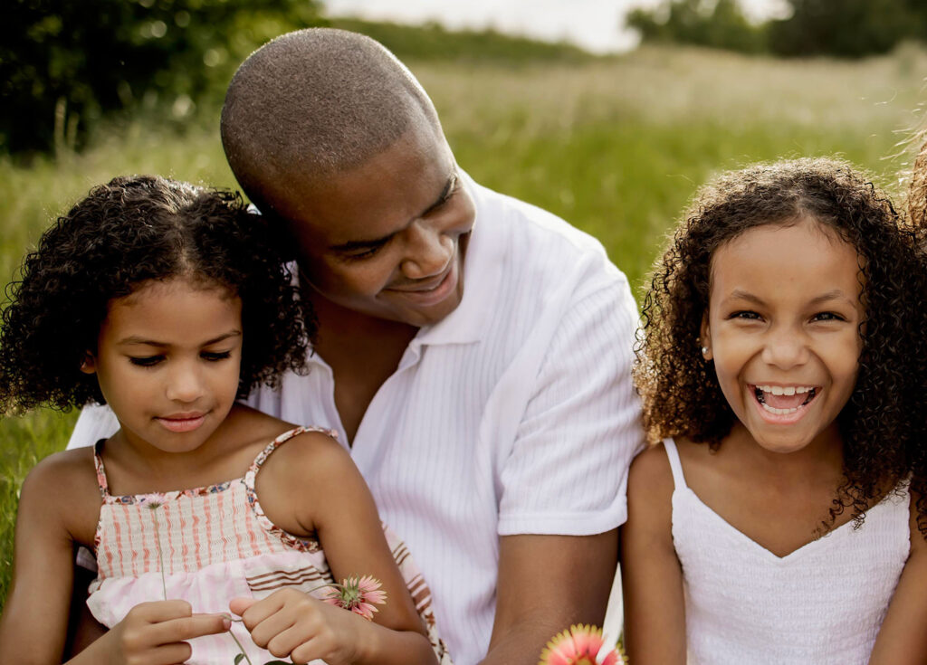 father and his daughters at a family session in Plano Texas